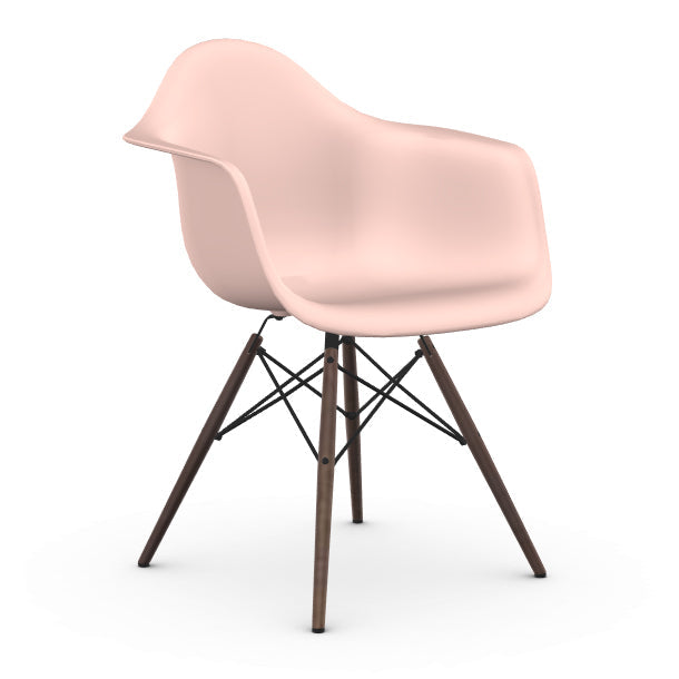 Pink Eames chair with wooden legs on a white background