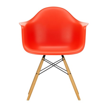 Red Eames chair with wooden legs on a white background