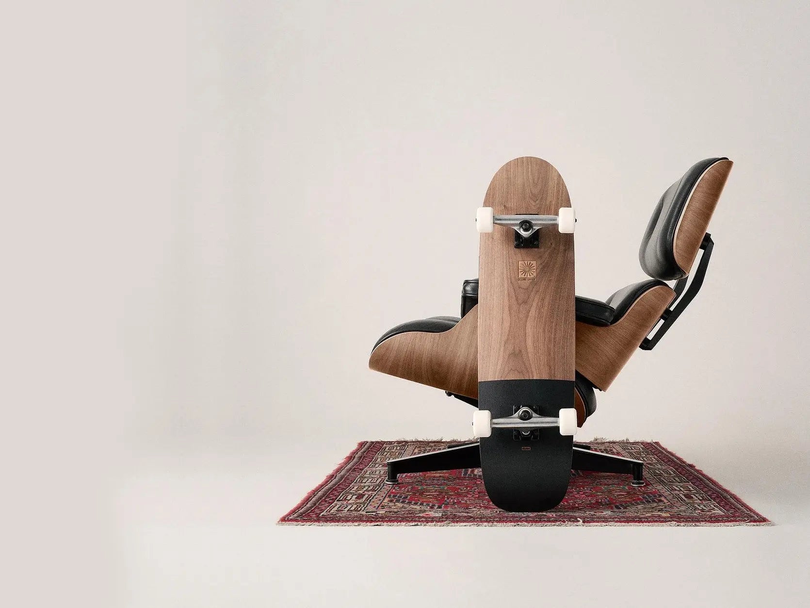 Bent plywood frame with rosewood finish, leather upholstery, and die-cast aluminum base. Measurements: Lounge Chair approximately 84 cm x 84 cm x 84 cm (height, width, depth)Present manufacturer's mark under the base.